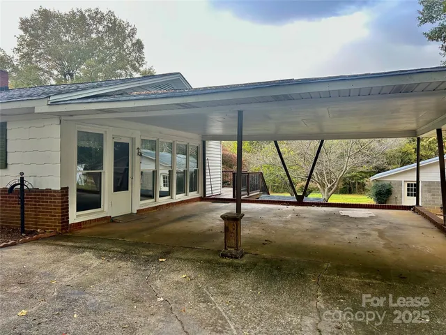 a view of a yard with a house and a tree