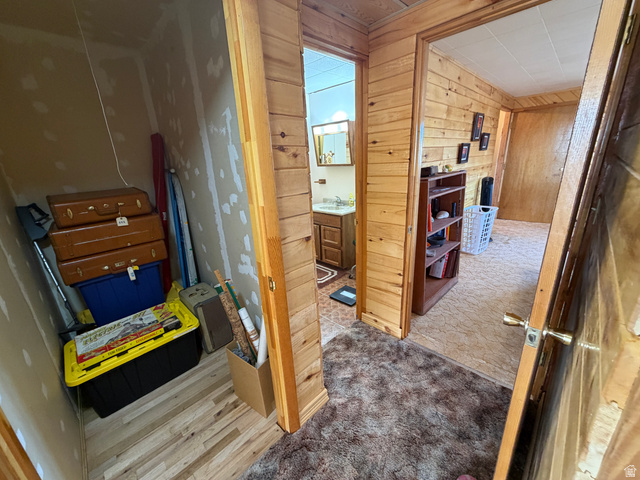 358 South Sky Drive Torrey, UT 84775 - Photo 26 of 82 Hallway with wood-paneled walls and a built-in bookshelf