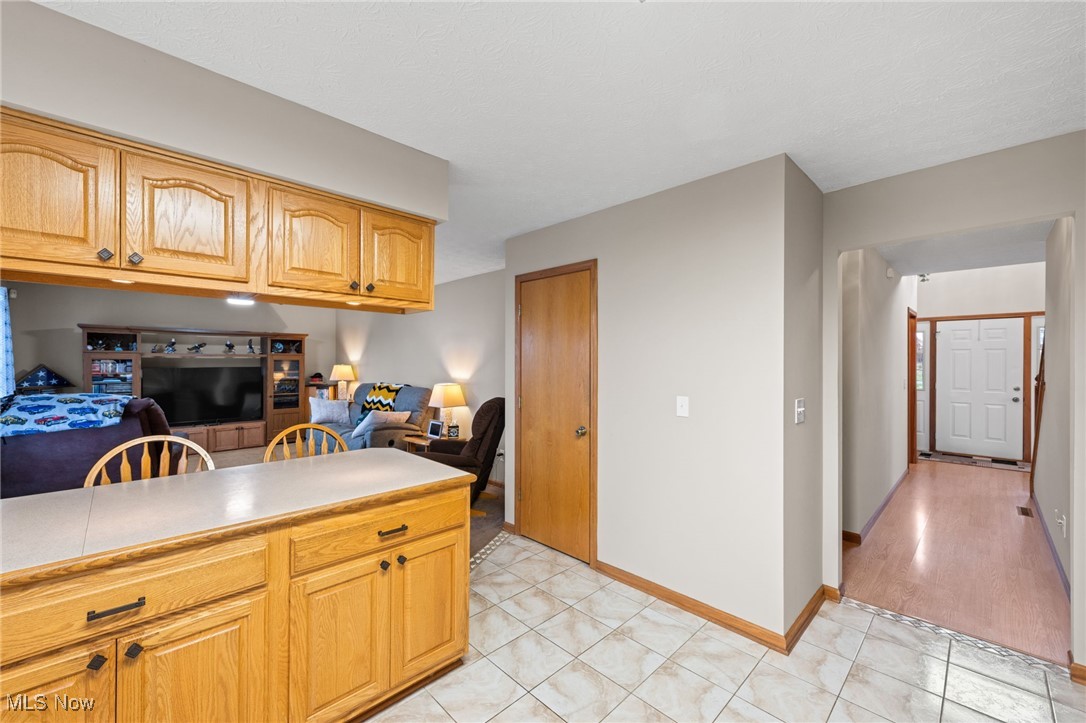 7939 Giddings Road Rootstown, OH 44272 - Photo 41 of 41 Kitchen with light countertops, open floor plan, light tile patterned flooring, and light brown cabinetry
