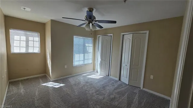 a view of a livingroom with a ceiling fan and window