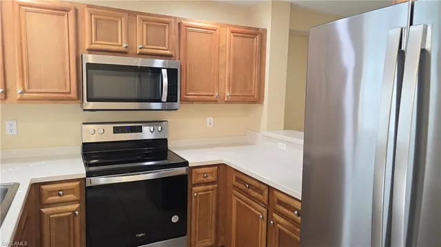 a kitchen with appliances and cabinets