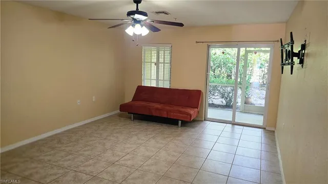 a view of a livingroom with furniture and a ceiling fan