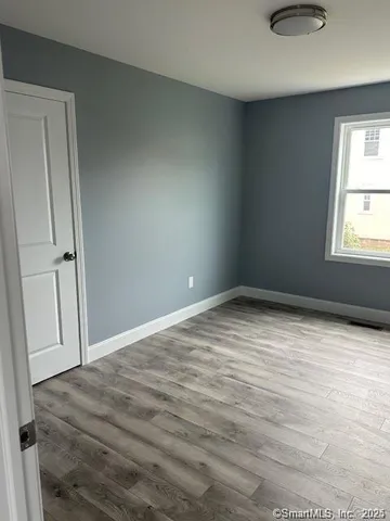an empty room with windows and closet