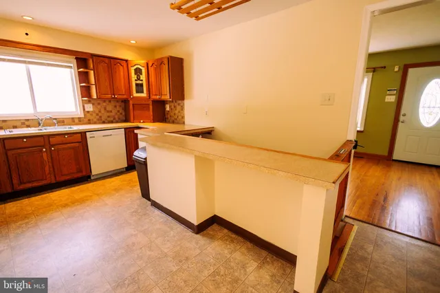 a utility room with sink dryer and washer