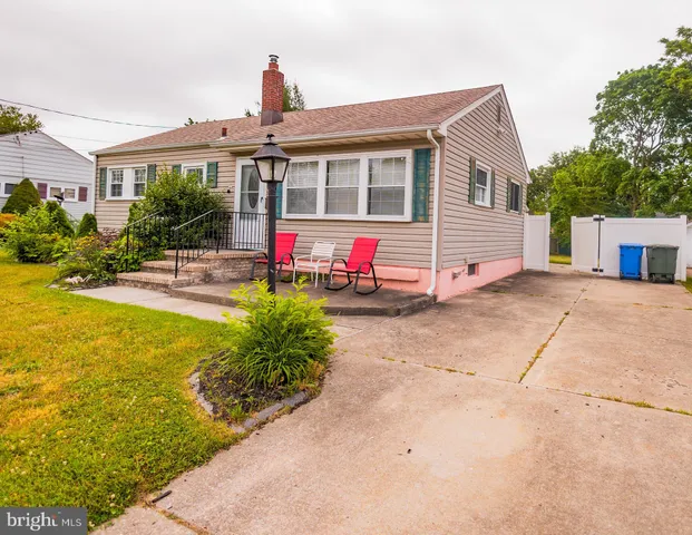 a front view of house with an outdoor space and seating