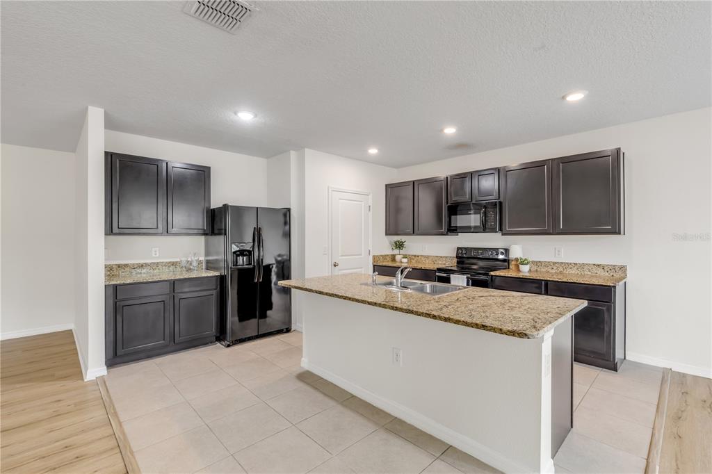 48 Hickory Loop Ocala, FL 34472 - Photo 12 of 52 a large kitchen with a large counter top stainless steel appliances and cabinets