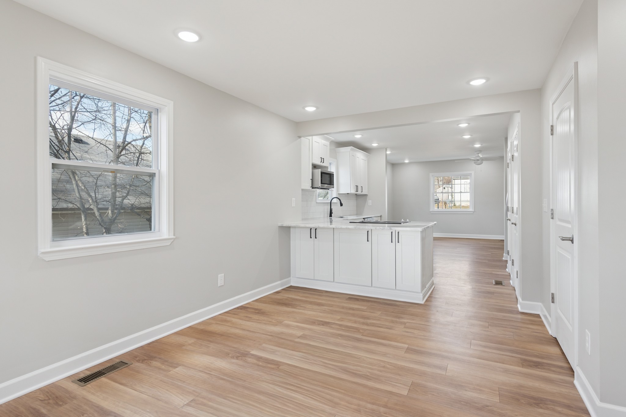 112 Wiley Street Madison, TN 37115 - Photo 21 of 43 a view of a kitchen with wooden floor and a window