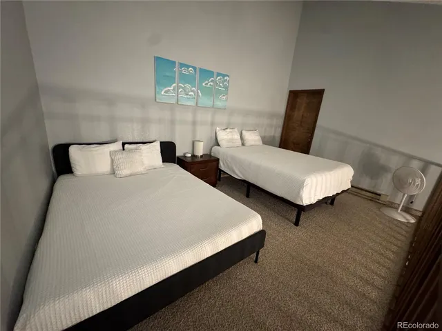 a bed room with double bed and a tv