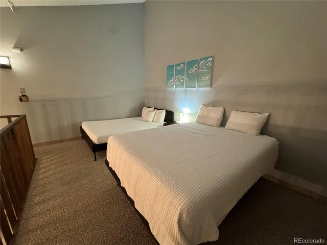 a bedroom with double bed and a night stand