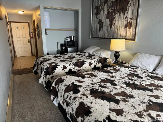 a bed sitting in a bedroom next to a window