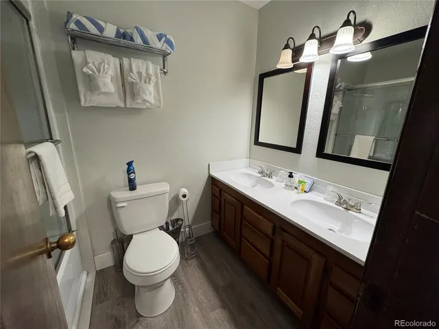 a bathroom with a toilet and a shower
