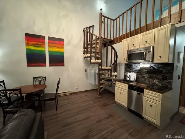 a view of a dining room with furniture and wooden floor