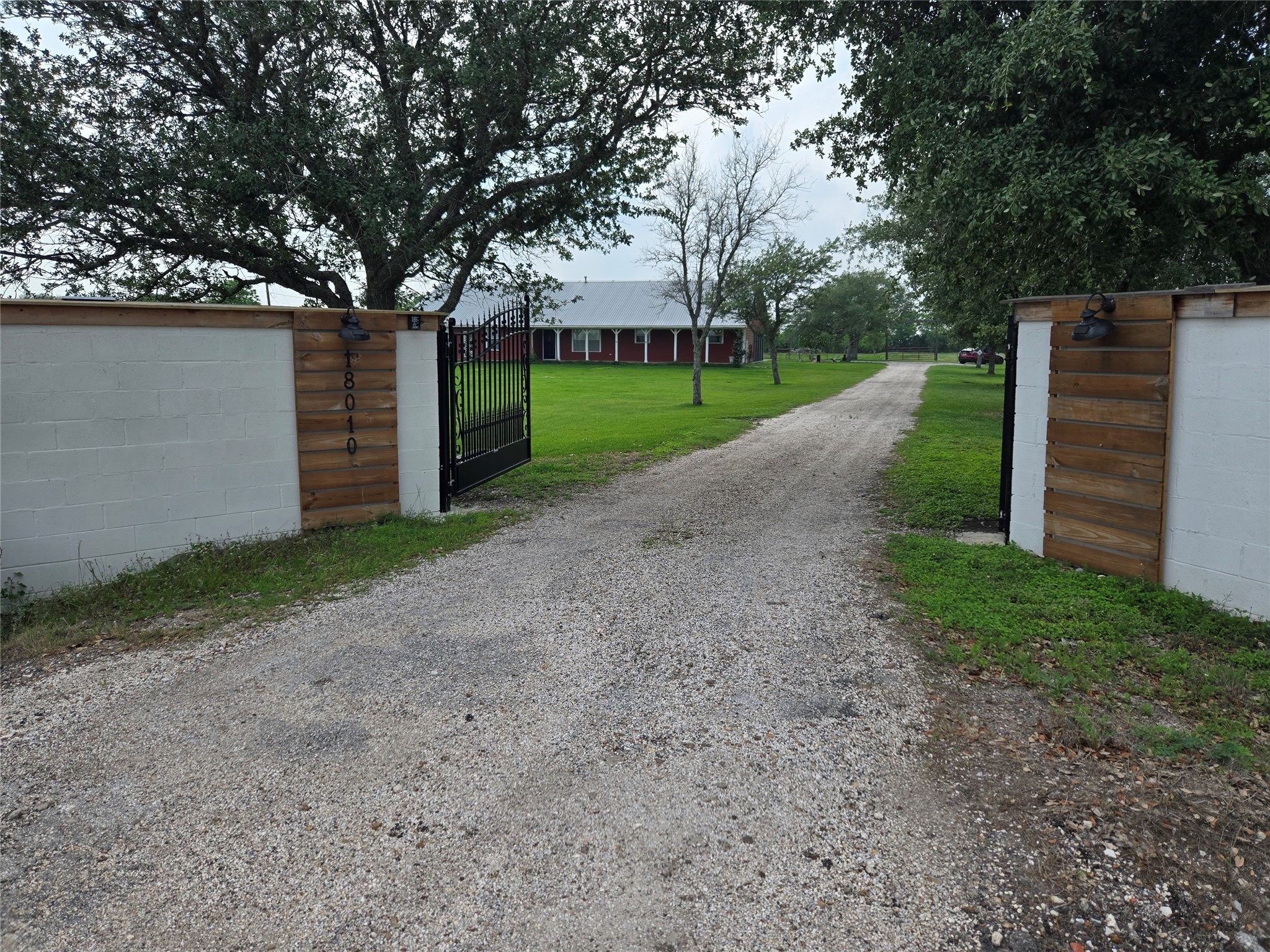 18010 County Road 48 Rosharon, TX 77583 - Photo 1 of 13 a view of a house with a yard and a large tree