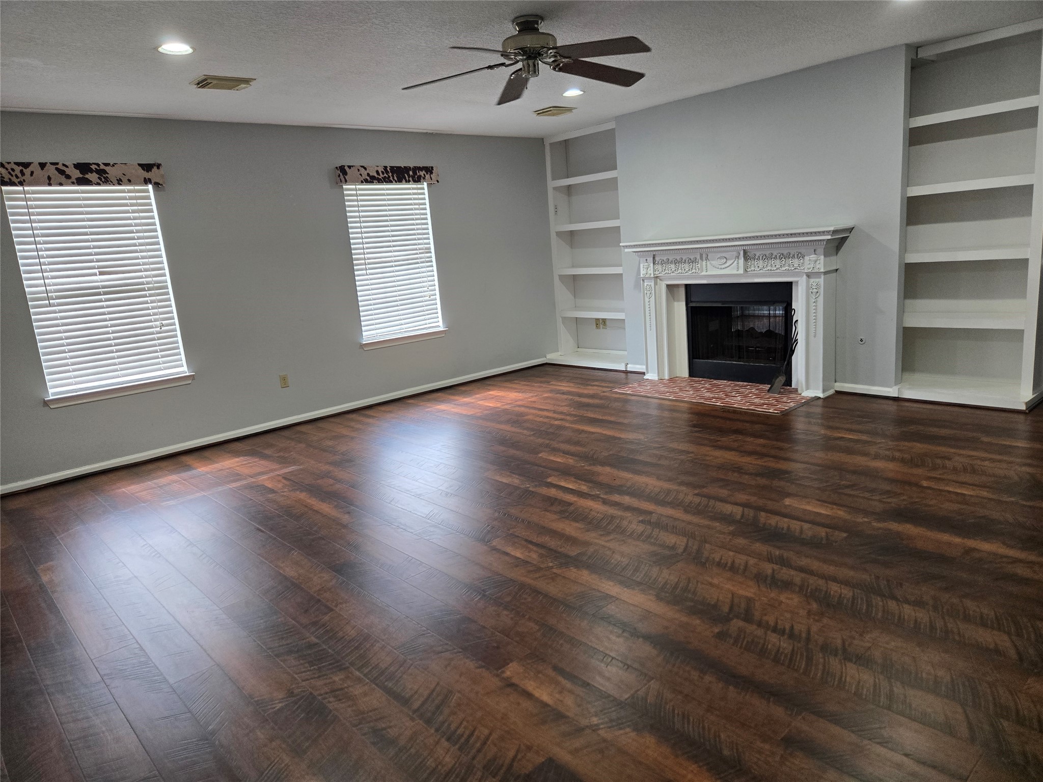 18010 County Road 48 Rosharon, TX 77583 - Photo 8 of 13 an empty room with wooden floor fireplace and windows