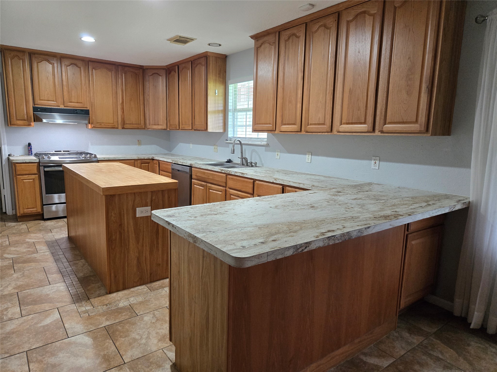 18010 County Road 48 Rosharon, TX 77583 - Photo 9 of 13 a kitchen with stainless steel appliances granite countertop wooden cabinets a sink and dishwasher