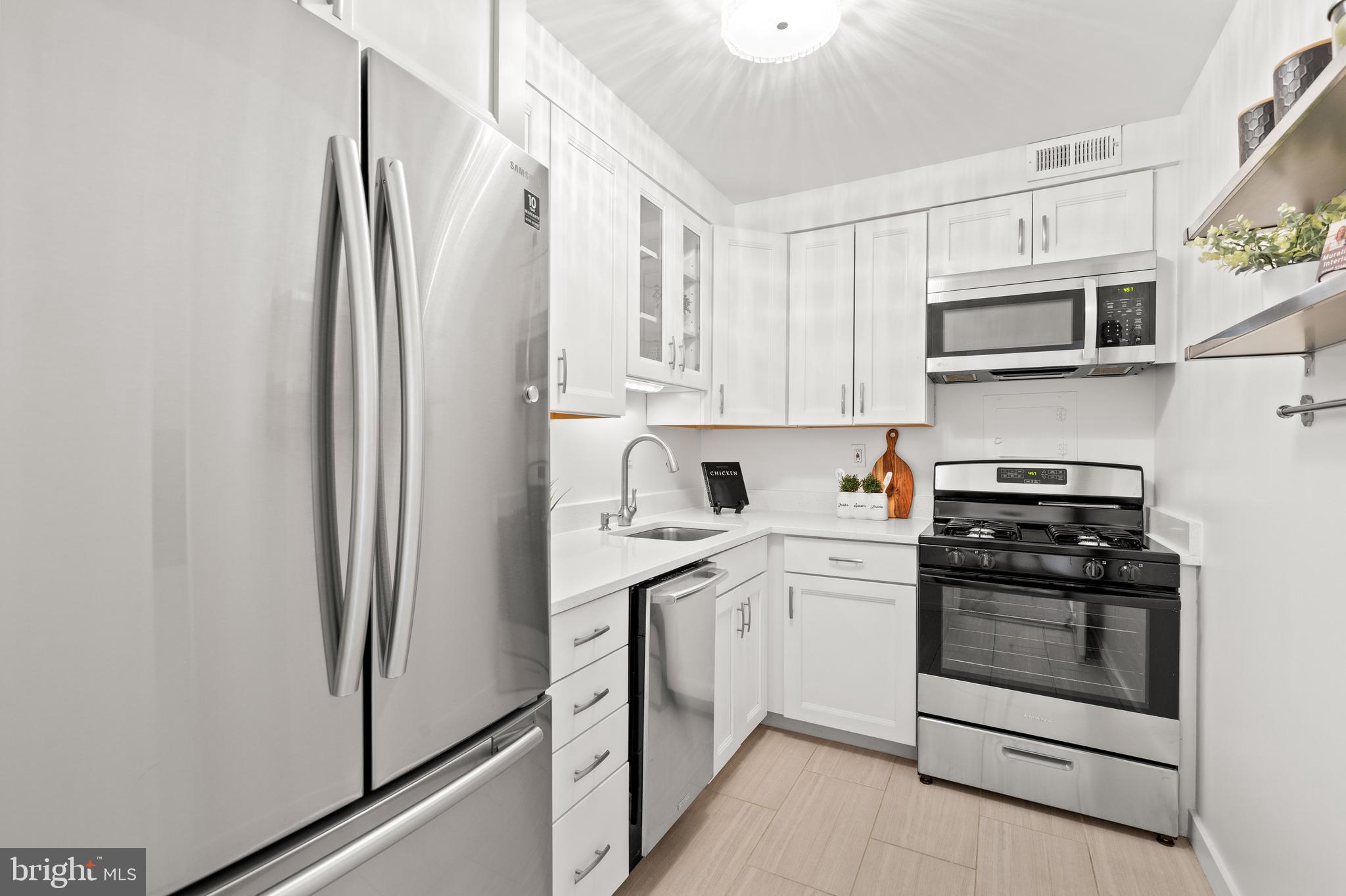 300 M Street Southwest, Unit N808 Washington, DC 20024 - Photo 13 of 36 a kitchen with stainless steel appliances a refrigerator sink and cabinets