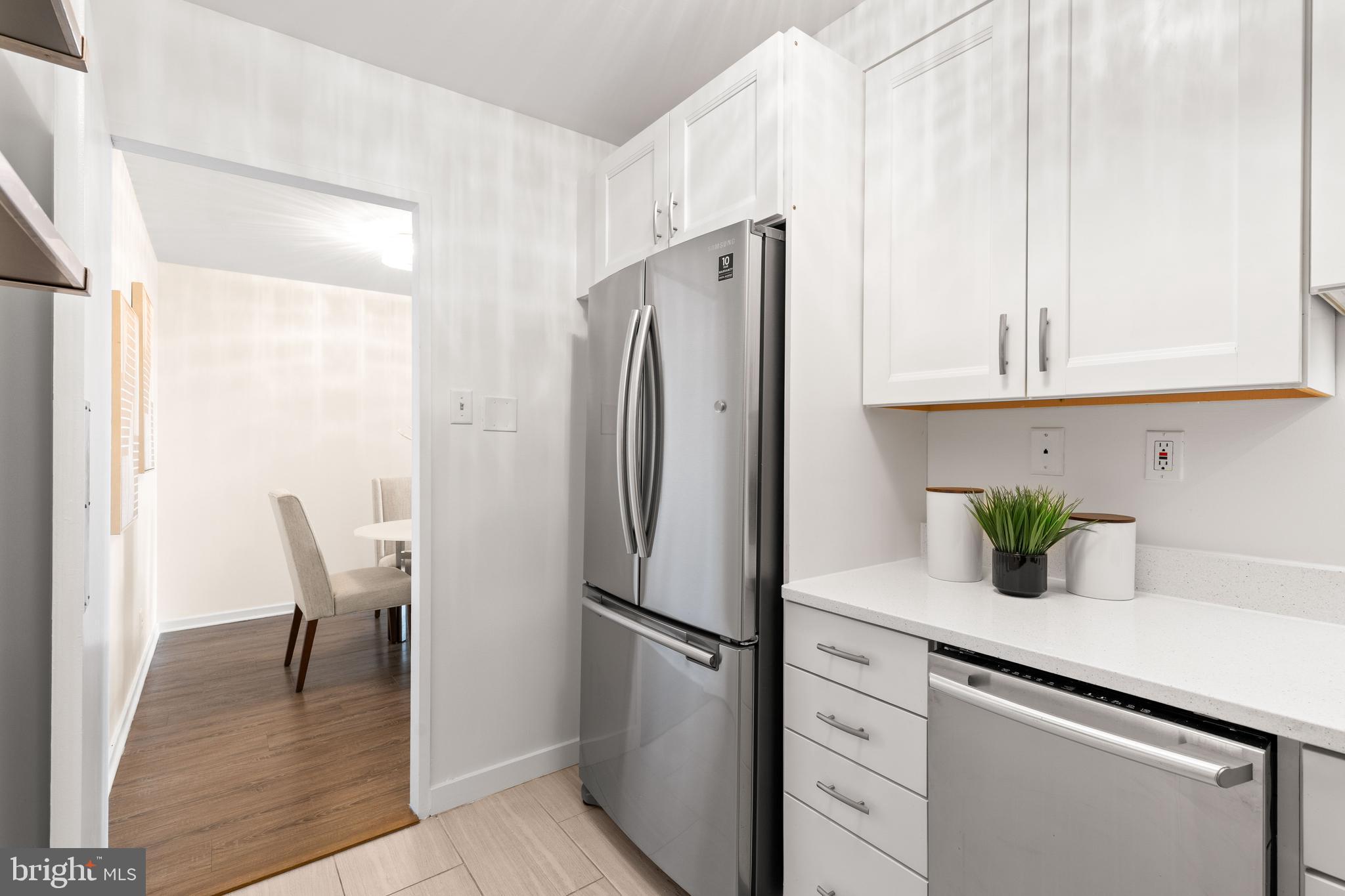 300 M Street Southwest, Unit N808 Washington, DC 20024 - Photo 15 of 36 a kitchen with refrigerator and cabinets