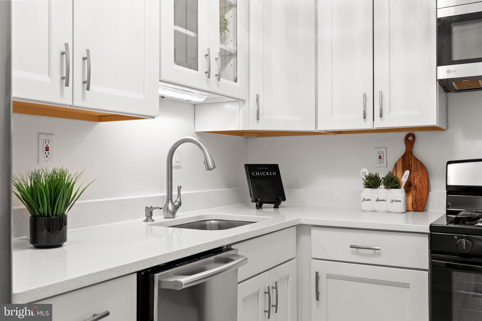 300 M Street Southwest, Unit N808 Washington, DC 20024 - Photo 18 of 36 a kitchen with stainless steel appliances white cabinets and a sink