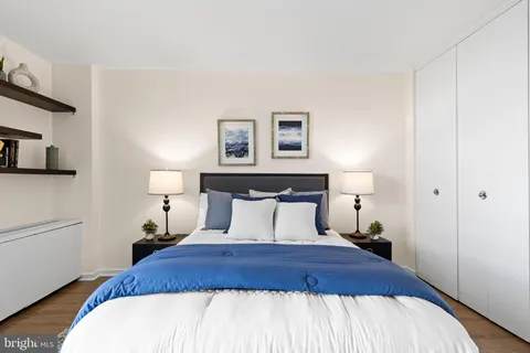 a bedroom with a bed and painting on the wall