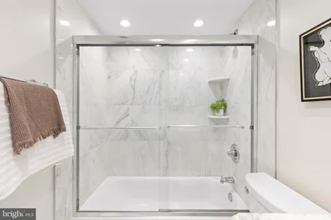 a bathroom with a shower and a tub