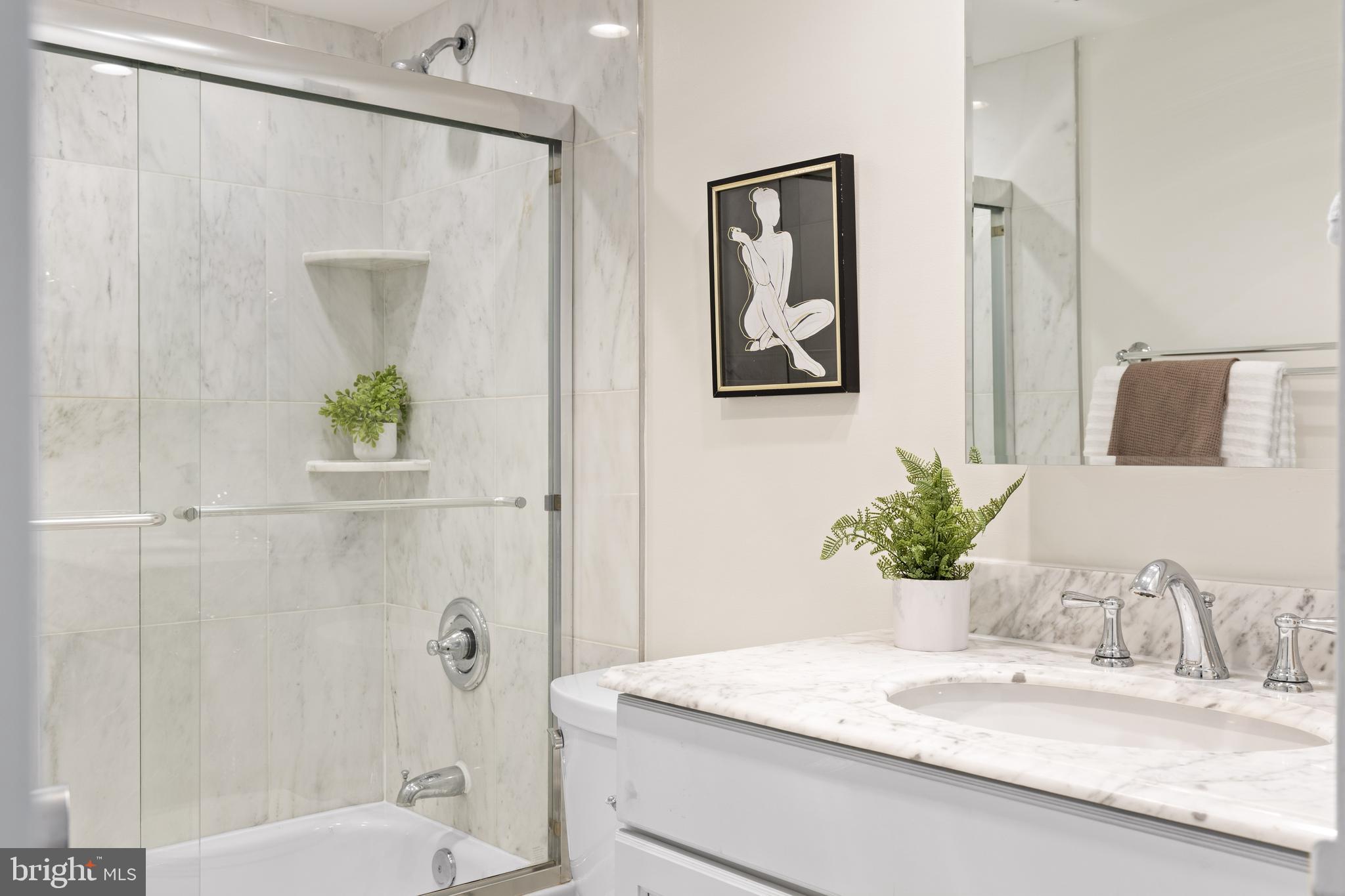 300 M Street Southwest, Unit N808 Washington, DC 20024 - Photo 26 of 36 a bathroom with a granite countertop sink a mirror and a shower