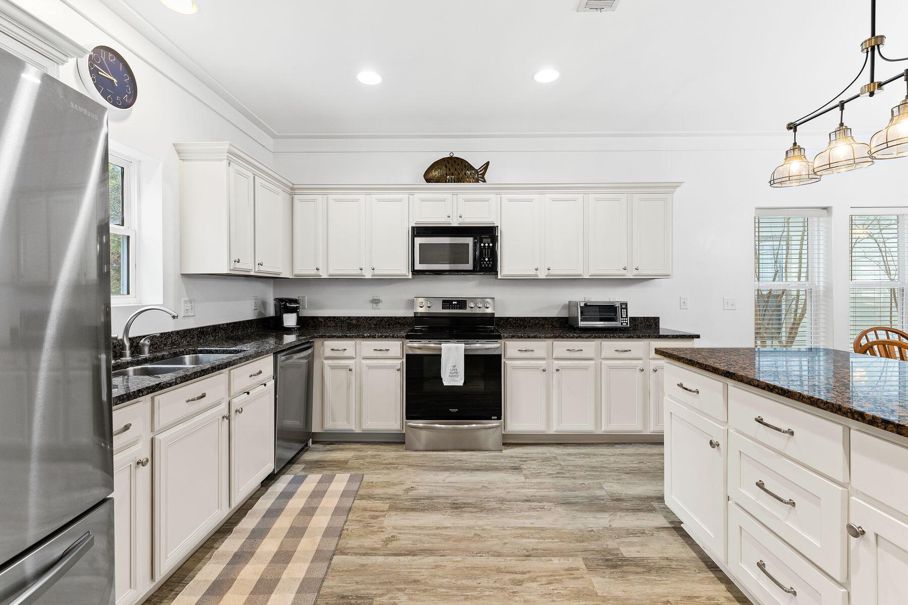 150 Cottage Way, Unit 20 Inlet Beach, FL 32461 - Photo 14 of 38 a kitchen with granite countertop white cabinets and black appliances