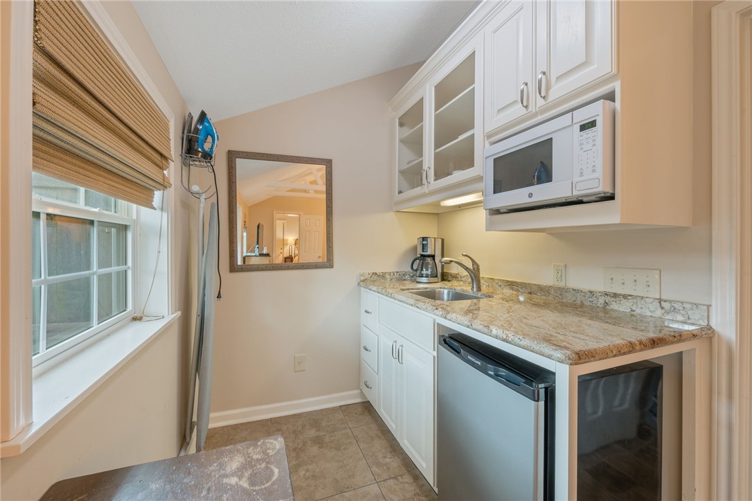 715 Inwood Drive Bryan, TX 77802 - Photo 14 of 34 a kitchen with stainless steel appliances granite countertop a sink and a microwave
