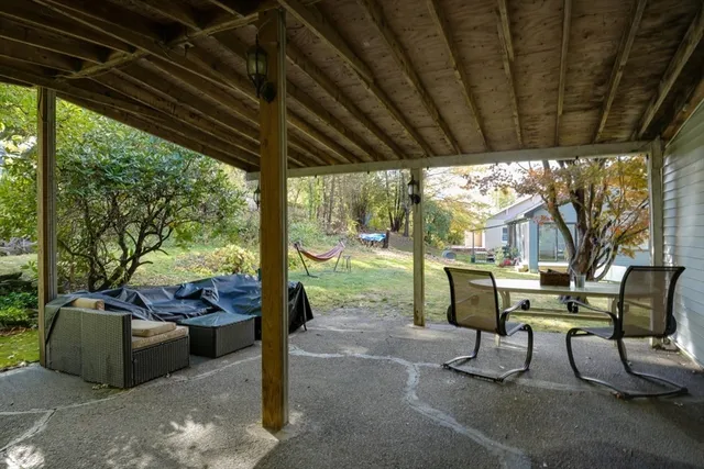 a building outdoor space with patio furniture and potted plants