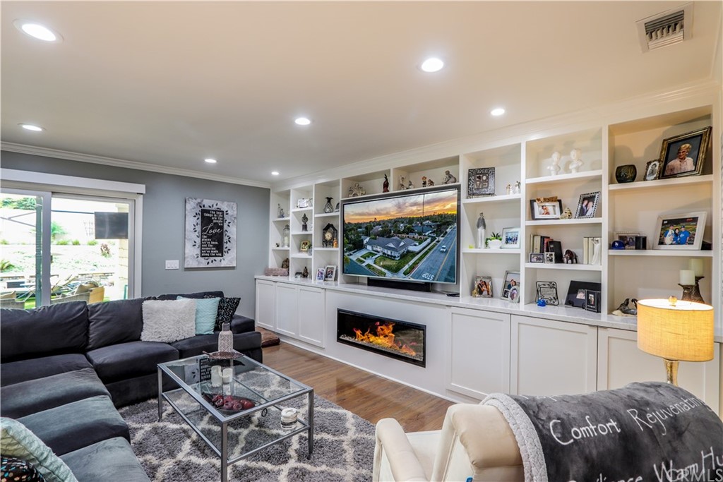 3213 Twilight Drive Fullerton, CA 92835 - Photo 8 of 47 a living room with furniture a flat screen tv and a floor to ceiling window