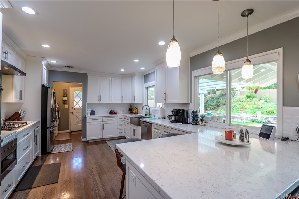 3213 Twilight Drive Fullerton, CA 92835 - Photo 10 of 47 a kitchen with stainless steel appliances a stove top oven a refrigerator a sink and dining table