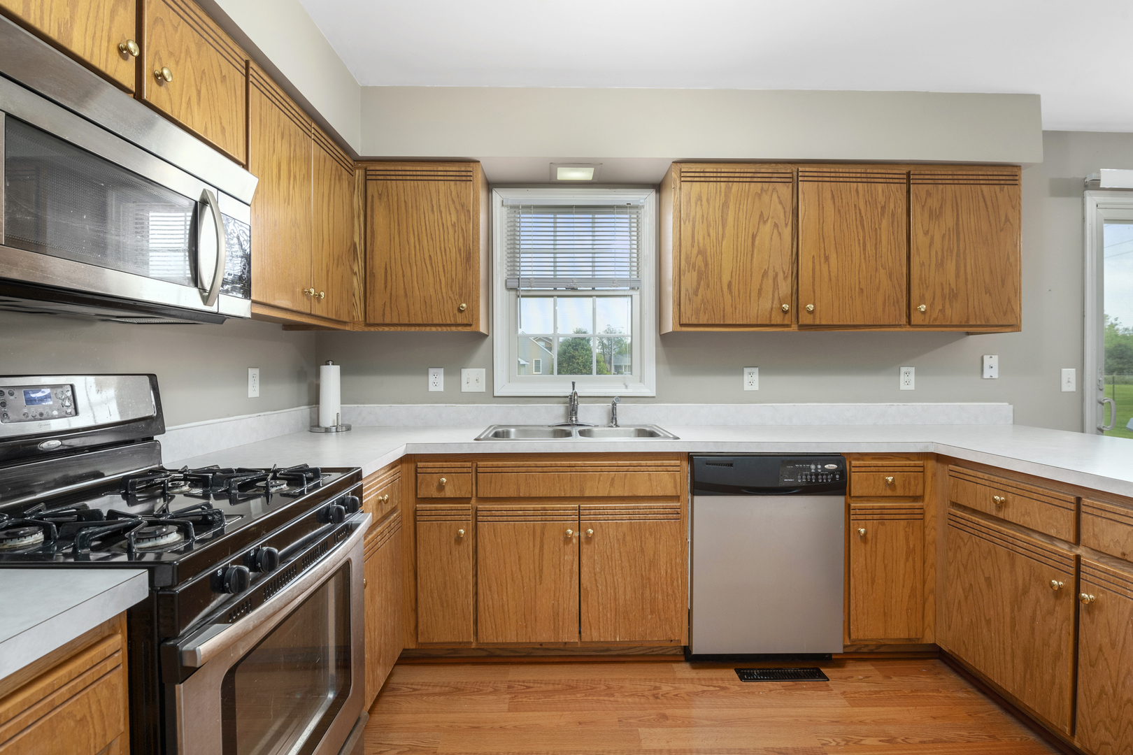 522 Hunters Run Coal City, IL 60416 - Photo 6 of 24 a kitchen with stainless steel appliances granite countertop a stove and a sink