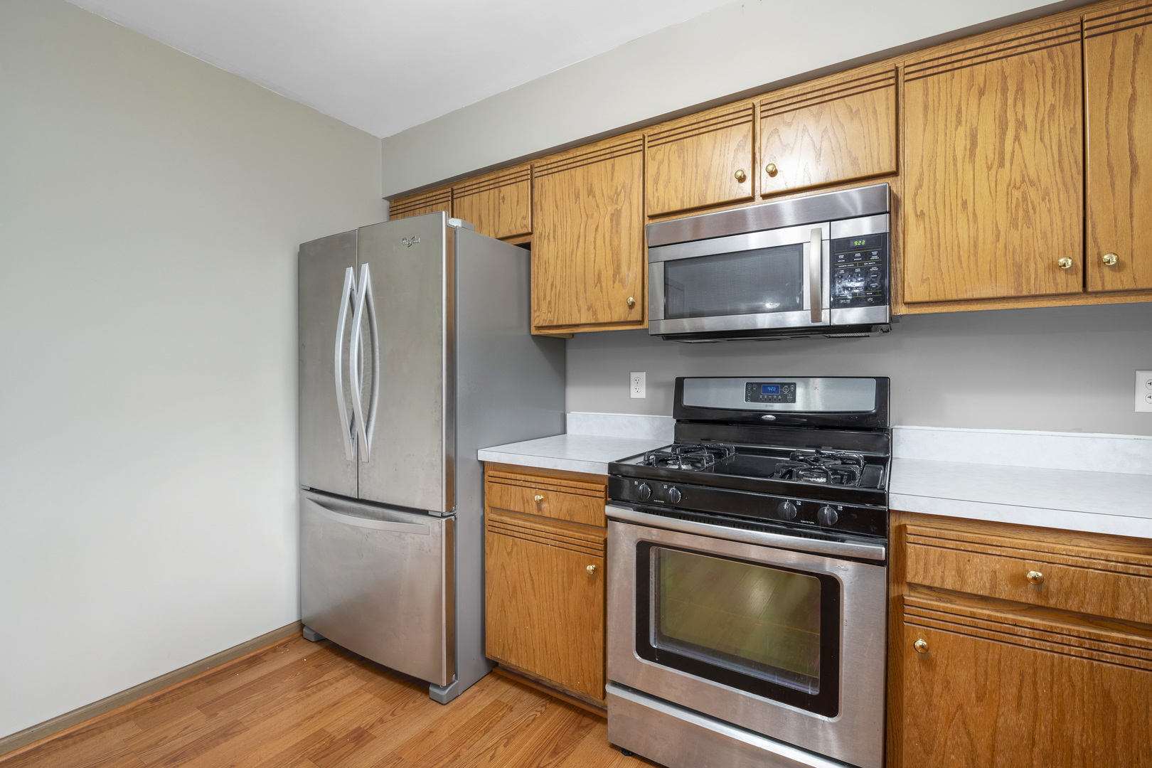 522 Hunters Run Coal City, IL 60416 - Photo 7 of 24 a kitchen with stainless steel appliances granite countertop a stove microwave refrigerator and cabinets