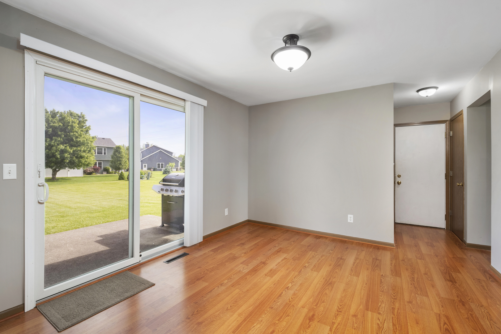 522 Hunters Run Coal City, IL 60416 - Photo 9 of 24 a view of an empty room with wooden floor and a window