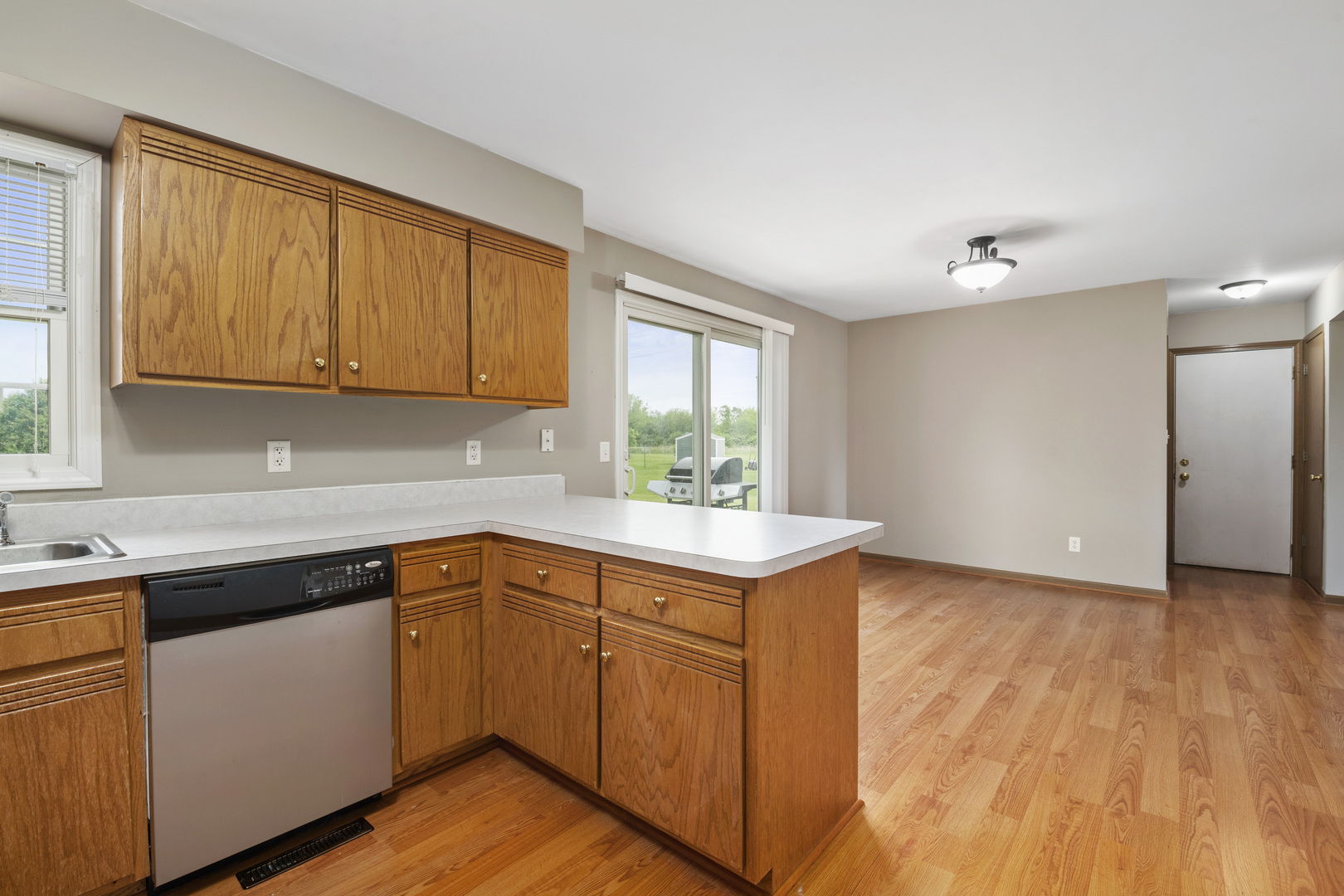 522 Hunters Run Coal City, IL 60416 - Photo 10 of 24 a kitchen with a sink cabinets and wooden floor