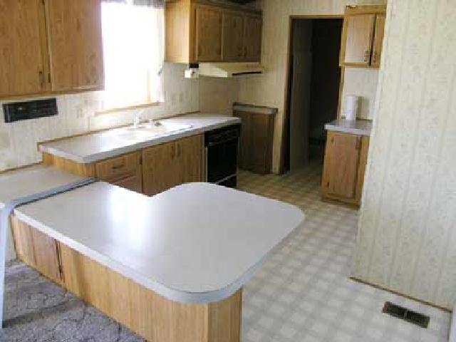 3153 Beaudry Road Moxee, WA 98936 - Photo 2 of 8 a kitchen with stainless steel appliances granite countertop a sink a stove and a refrigerator