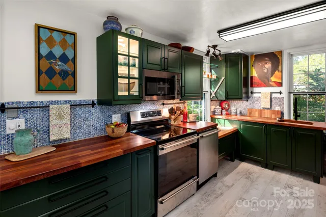 a kitchen with stainless steel appliances granite countertop a sink stove and cabinets
