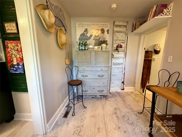 a view of a hallway with furniture and front door