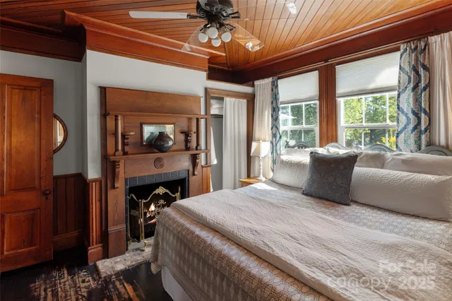 a bedroom with a large bed and a chandelier
