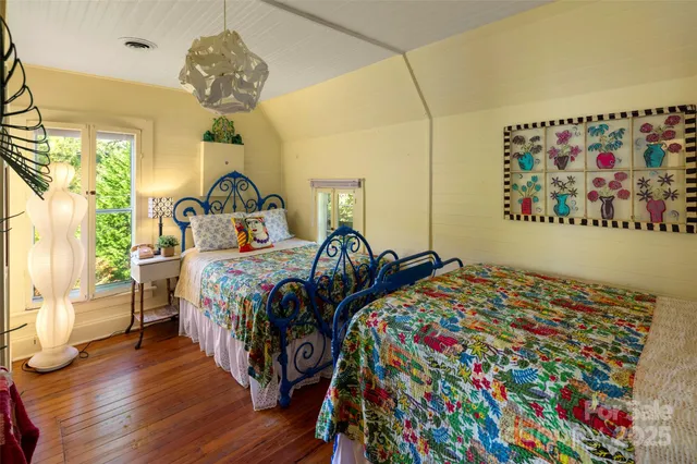 a bedroom with bed and wooden floor