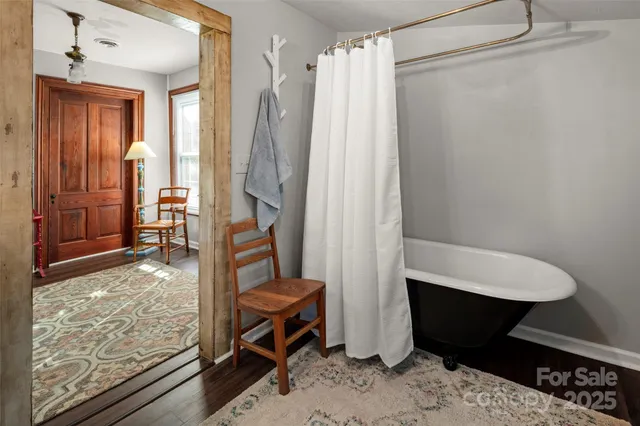 a living room with furniture a rug and white walls
