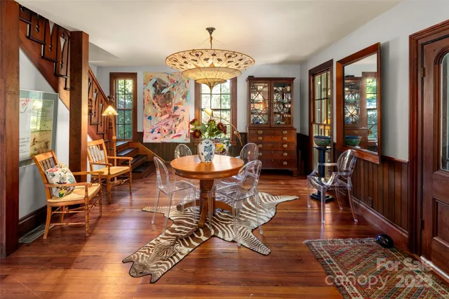 a living room with fireplace furniture and a chandelier