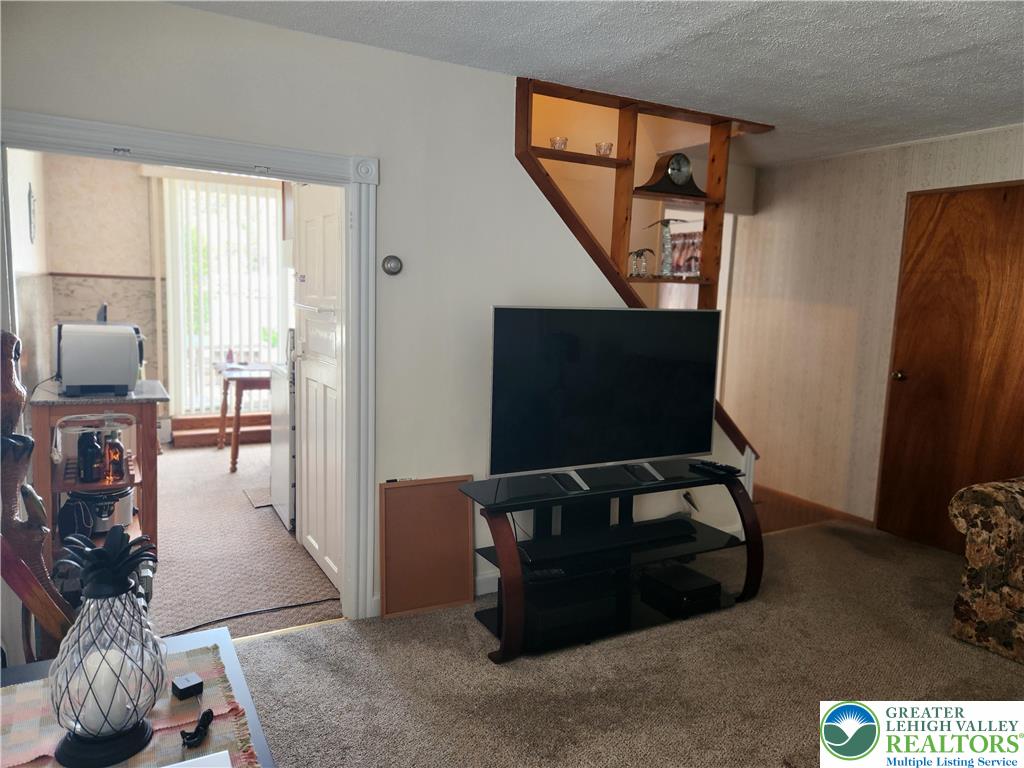 1795 Canal Street, Unit R Northampton, PA 18067 - Photo 10 of 15 a living room with furniture a flat screen tv and a window