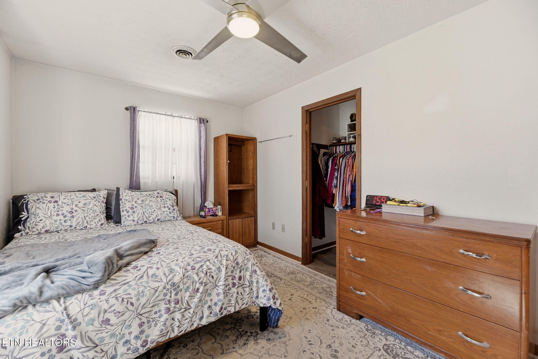 148 Batley Loop Road Clinton, TN 37716 - Photo 16 of 30 a bedroom with a bed and a dresser