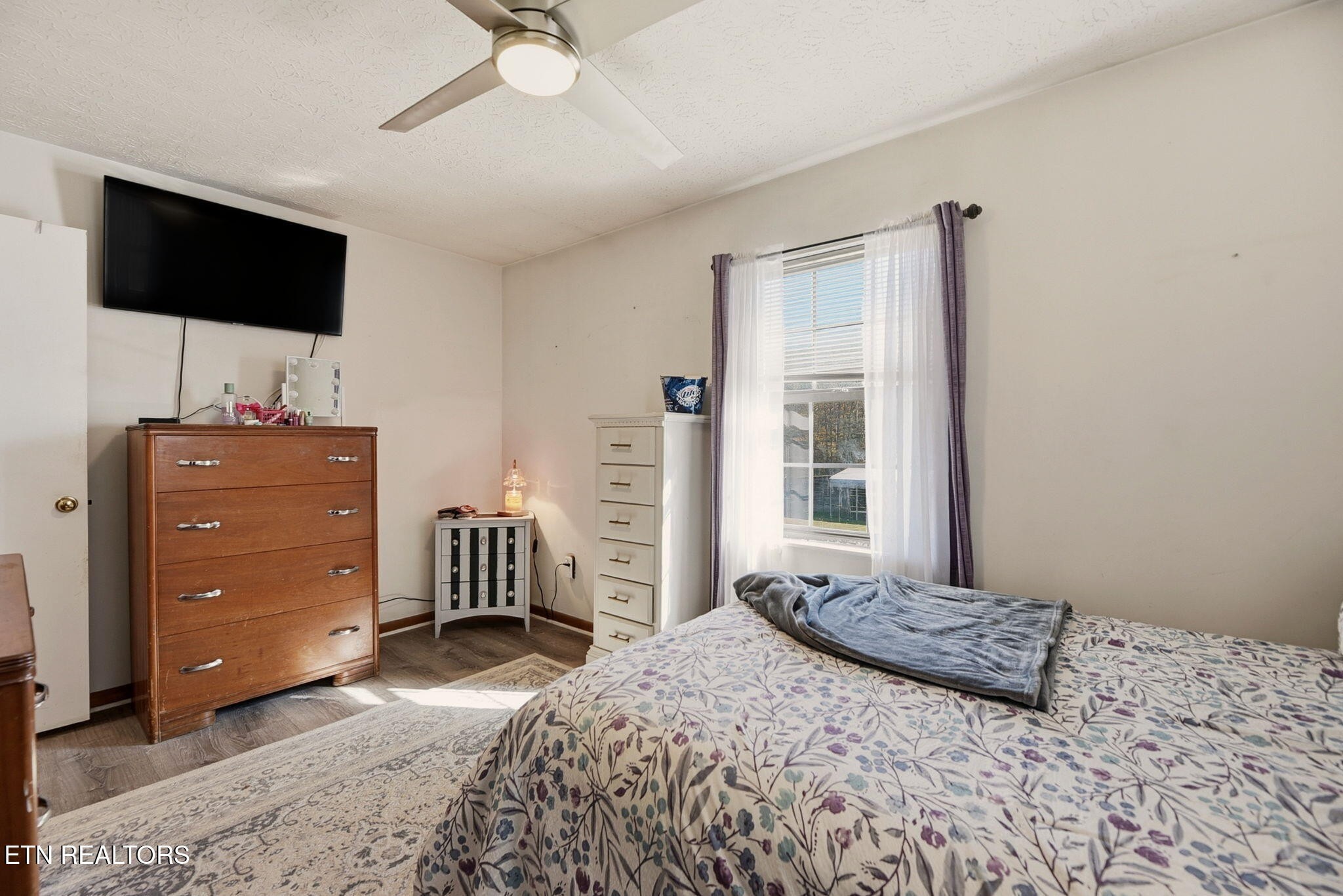 148 Batley Loop Road Clinton, TN 37716 - Photo 17 of 30 a bedroom with a bed and flat screen tv