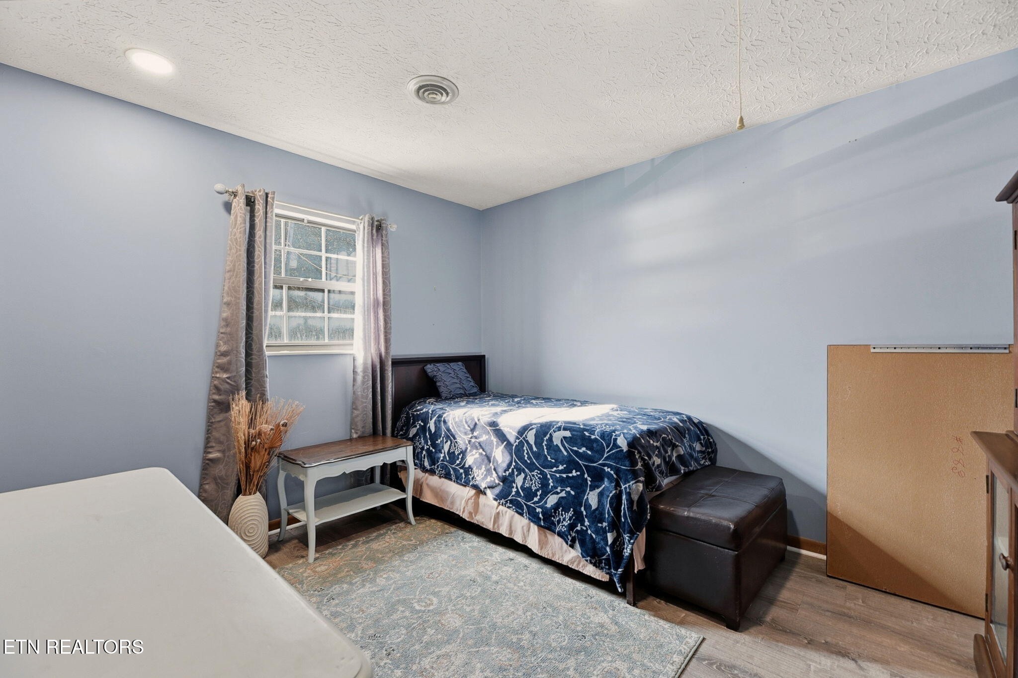 148 Batley Loop Road Clinton, TN 37716 - Photo 18 of 30 a bedroom with a bed and a window