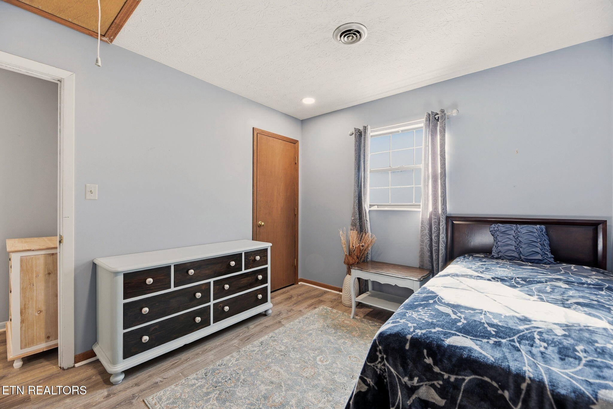 148 Batley Loop Road Clinton, TN 37716 - Photo 19 of 30 a bedroom with a bed and a dresser
