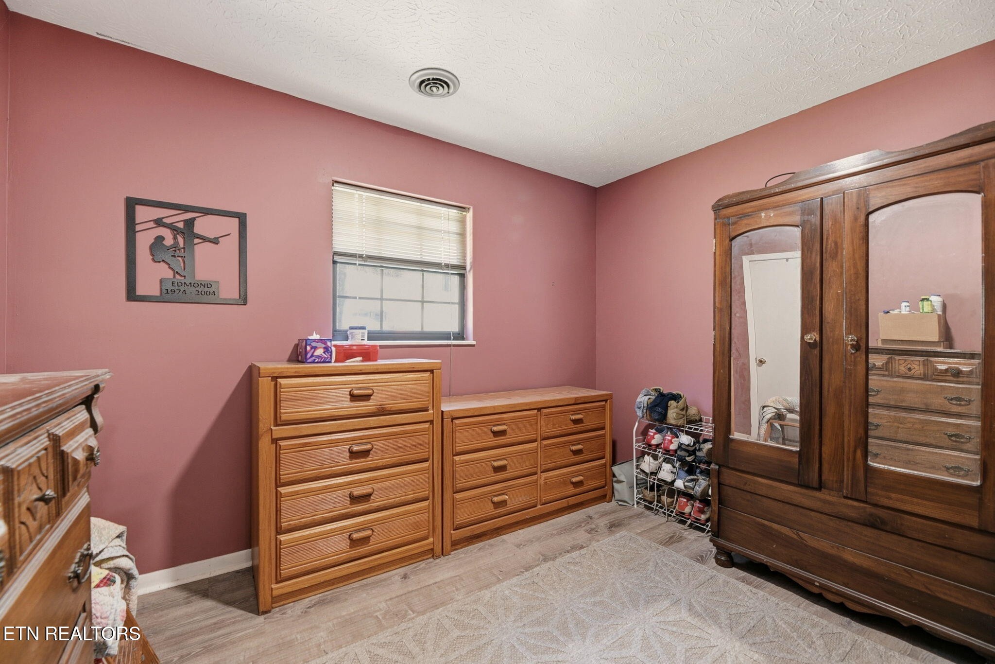 148 Batley Loop Road Clinton, TN 37716 - Photo 21 of 30 a bed room with a bed and a dresser