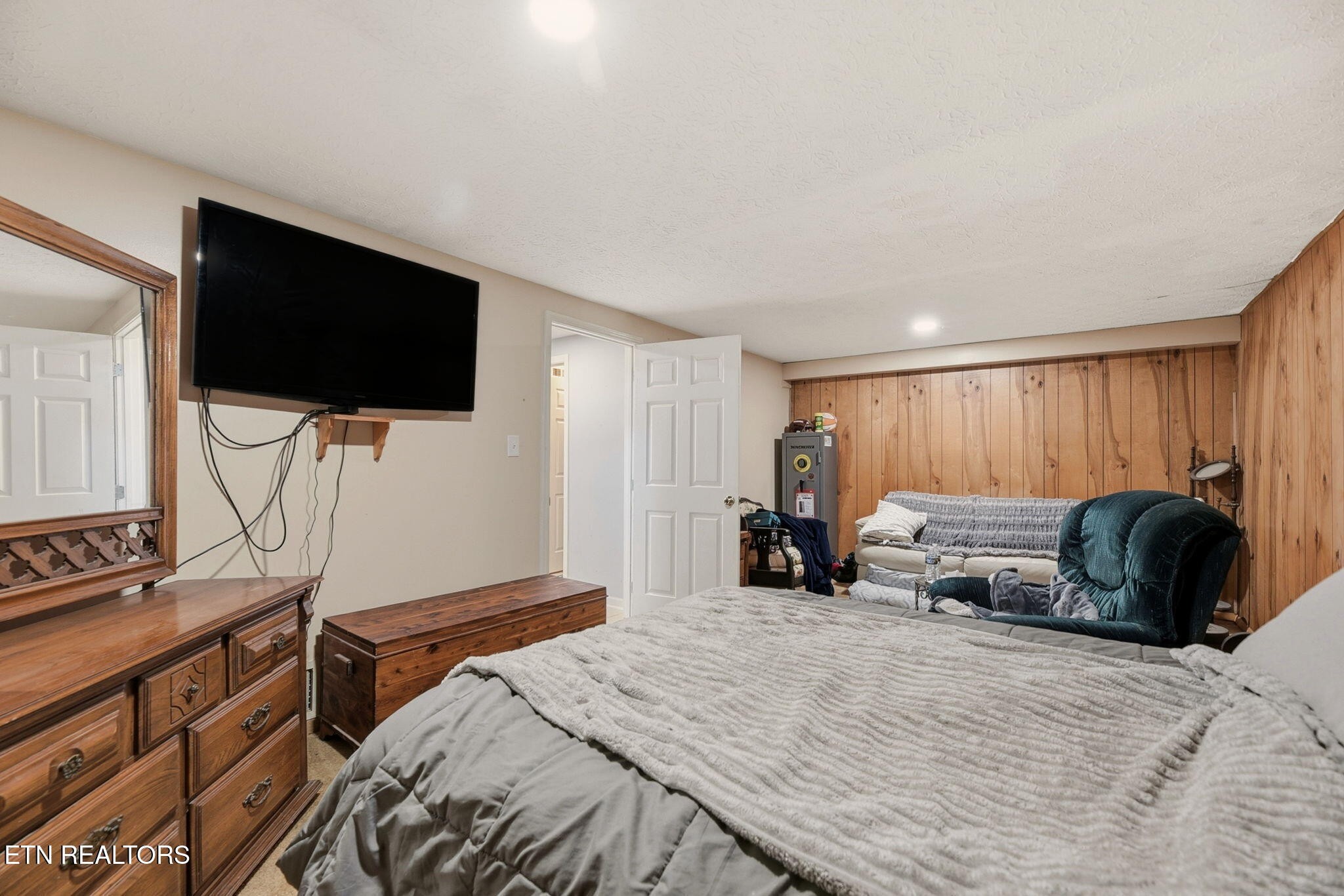 148 Batley Loop Road Clinton, TN 37716 - Photo 24 of 30 a bedroom with a bed and a flat screen tv