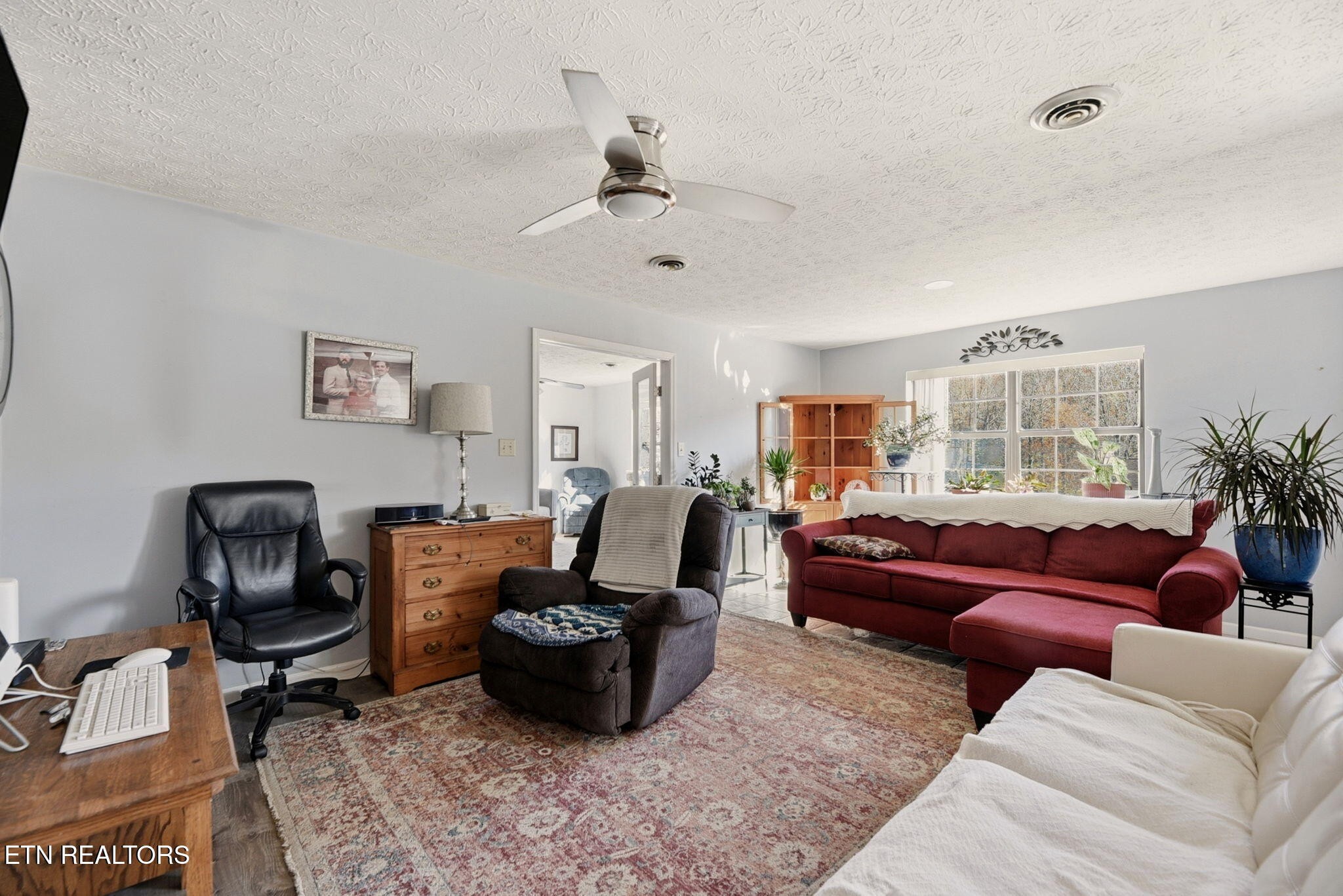 148 Batley Loop Road Clinton, TN 37716 - Photo 4 of 30 a living room with furniture ceiling fan and a rug