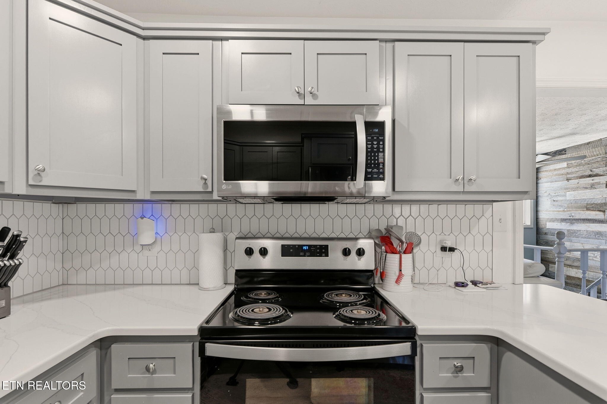 148 Batley Loop Road Clinton, TN 37716 - Photo 10 of 30 a kitchen with white cabinets and a stove top oven